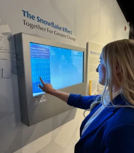 Guest building their own snowflake to add to the snowfall in the Snowflake Effect digital exhibit at the Lake Placid Olympic Museum
